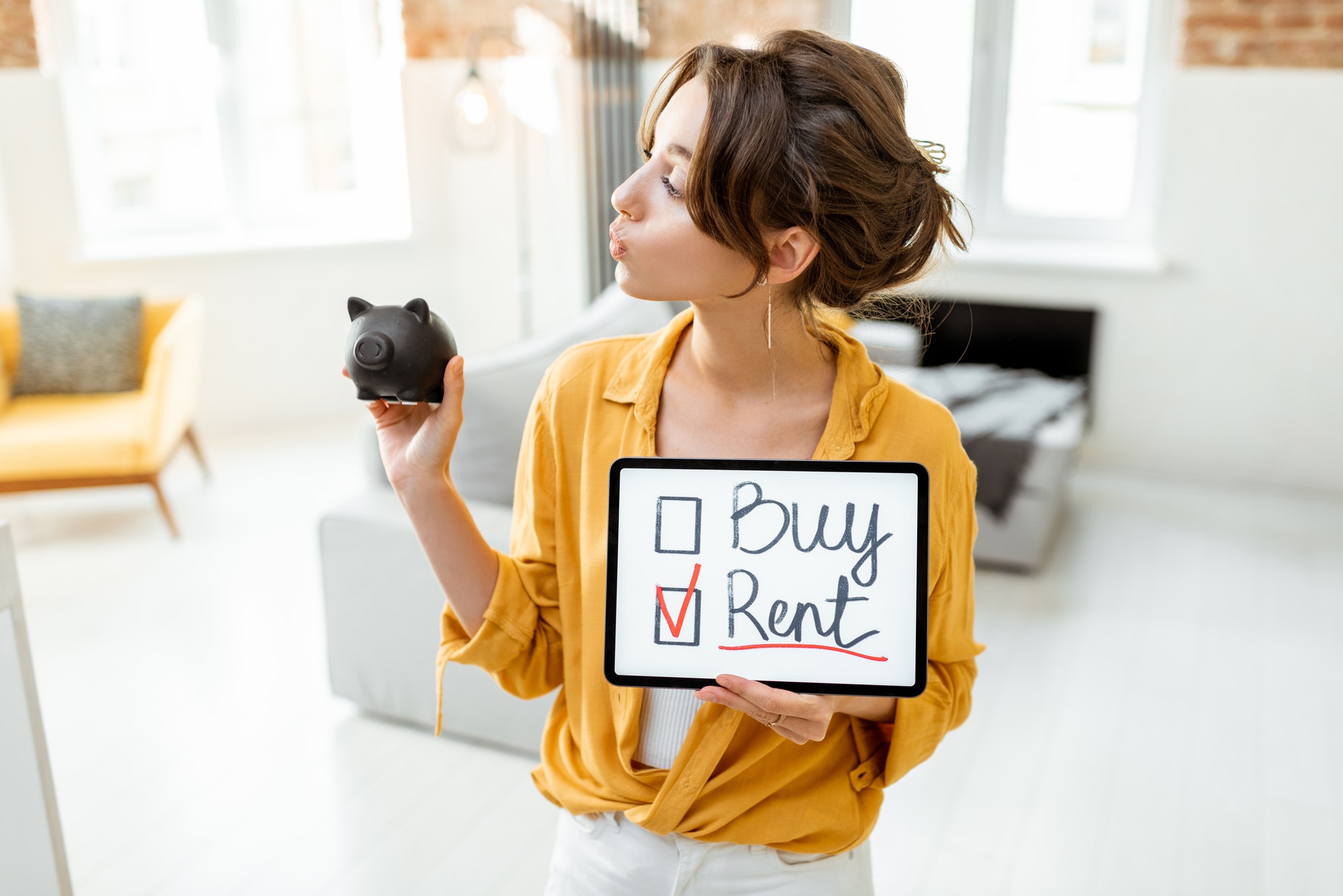 Woman decides between buying or renting house Woman decides between buying or renting house